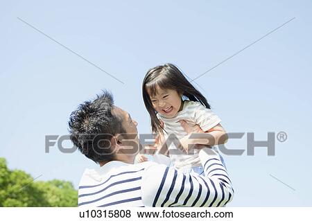 Father picking up daughter View Large Photo Image Stock Photo - Father picking up daughter. Fotosearch