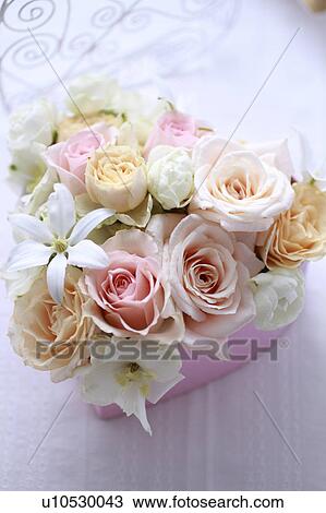 Stock Image - Flowers Put In Heart-shaped Box. Fotosearch