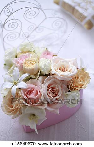 Stock Image - Flowers Put In Heart-shaped Box. Fotosearch