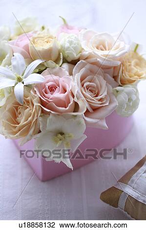 Stock Image - Flowers Put In Heart-shaped Box. Fotosearch