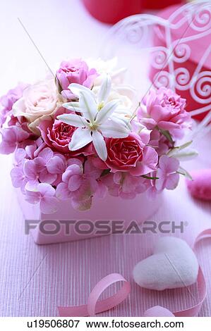 Stock Photo - Flowers Put In Heart-shaped Box. Fotosearch