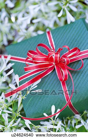 Stock Image - Gift box and white flowers. Fotosearch
