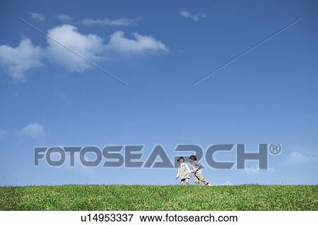 Stock Photo - Girl and Boy in Field. Fotosearch