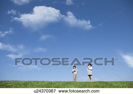 Girl and Boy with Tin Can Phone in Field View Large Photo Image Stock Photo - Girl and Boy with Tin Can Phone in Field. Fotosearch