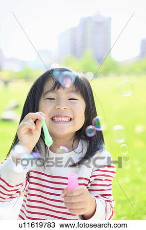 Girl blowing bubbles View Large Photo Image Stock Image - Girl blowing bubbles. Fotosearch