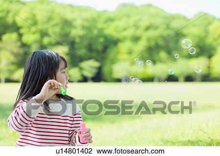 Girl blowing bubbles View Large Photo Image Stock Image - Girl blowing bubbles. Fotosearch