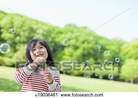 Girl blowing bubbles View Large Photo Image Stock Image - Girl blowing bubbles. Fotosearch