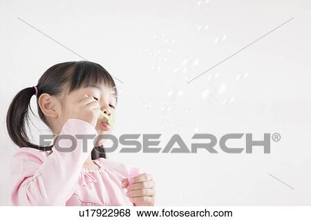 Stock Photo - Girl Blowing Bubbles. Fotosearch