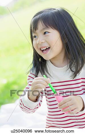 Girl blowing bubbles View Large Photo Image Stock Photograph - Girl blowing bubbles. Fotosearch