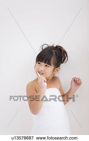 Stock Photo - Girl brushing teeth. Fotosearch