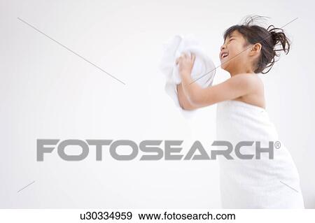 Stock Photo - Girl holding a towel and smiling. Fotosearch