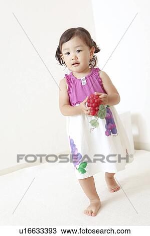 Girl holding toy grape View Large Photo Image Stock Image - Girl holding toy grape. Fotosearch