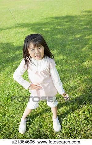 Girl holding wildflowers and hand on hip View Large Photo Image Stock Photograph - Girl holding wildflowers and hand on hip. Fotosearch