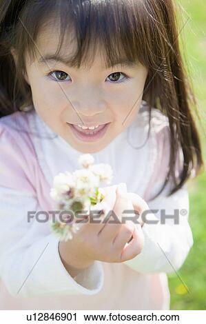 Girl holding wildflowers View Large Photo Image Stock Image - Girl holding wildflowers. Fotosearch