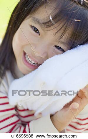 Girl hugging a towel View Large Photo Image Stock Photo - Girl hugging a towel. Fotosearch