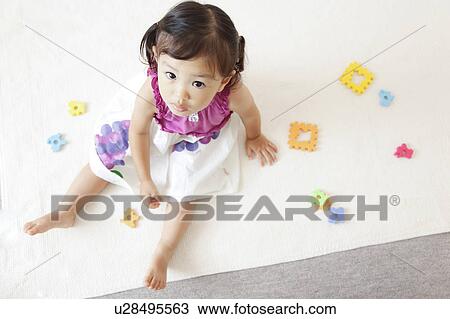 Stock Image - Girl looking at camera. Fotosearch