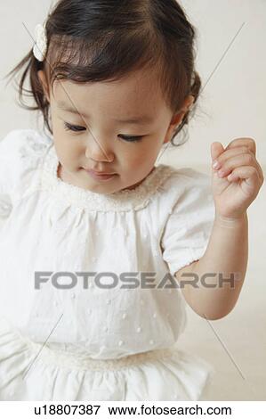 Stock Photo - Girl looking down. Fotosearch