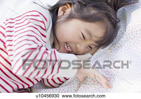 Girl lying down on picnic blanket View Large Photo Image Stock Image - Girl lying down on picnic blanket. Fotosearch