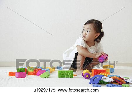 Girl playing with plastic blocks View Large Photo Image Stock Photography - Girl playing with plastic blocks. Fotosearch