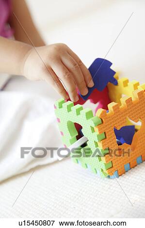 Girl playing with puzzle View Large Photo Image Stock Photo - Girl playing with puzzle. Fotosearch