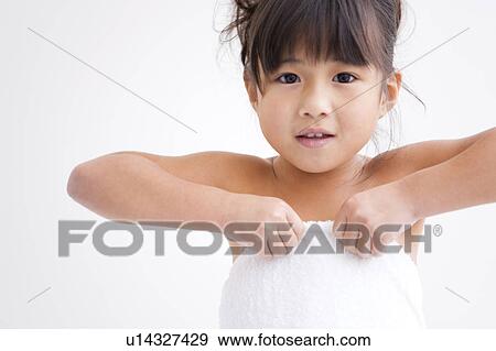 Girl pulling up a wrapped towel View Large Photo Image Stock Photo - Girl pulling up a wrapped towel. Fotosearch