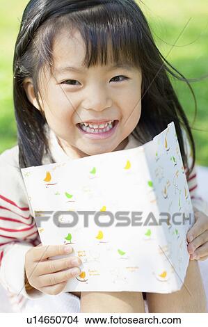 Girl reading a book View Large Photo Image Picture - Girl reading a book. Fotosearch