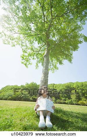 Stock Photo - Girl reading a book. Fotosearch