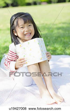 Girl reading a book View Large Photo Image Stock Photo - Girl reading a book. Fotosearch