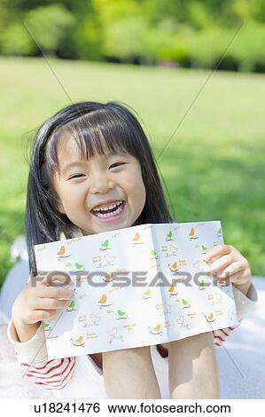 Stock Photograph - Girl reading a book. Fotosearch