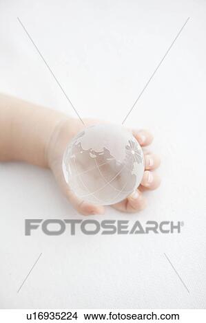 Picture - Glass Globe in Baby's Hand. Fotosearch