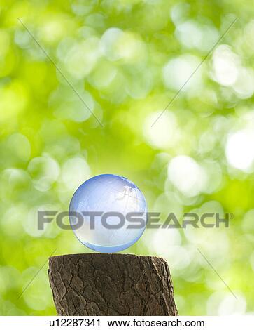 Stock Image - Globe Earth on Tree Stump. Fotosearch