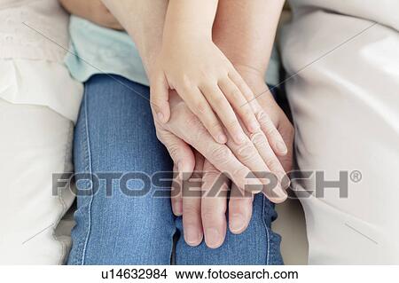 Picture - Grandparents and Granddaughter Holding Hands. Fotosearch