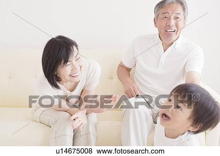 Grandparents Playing with Grandson on Sofa View Large Photo Image Stock Photo - Grandparents Playing with Grandson on Sofa. Fotosearch