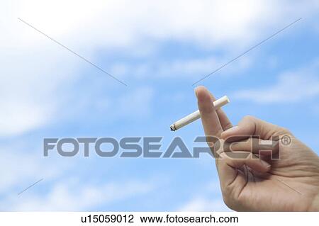 Stock Image - Hand Holding Cigarette. Fotosearch
