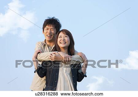 Stock Photo - Happy Couple Against Blue Sky. Fotosearch
