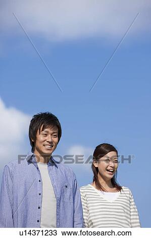 Happy Young Couple Against Blue Sky View Large Photo Image Stock Image - Happy Young Couple Against Blue Sky. Fotosearch