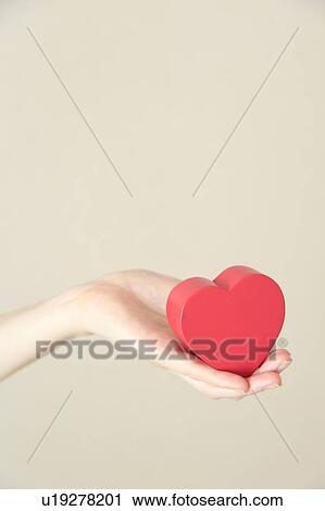 Heart shaped toy in hand View Large Photo Image Stock Image - Heart shaped toy in hand. Fotosearch
