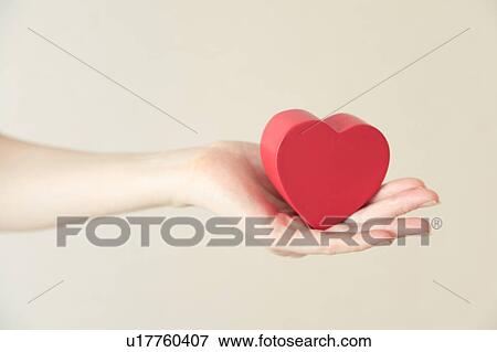 Heart shaped toy in hand View Large Photo Image Stock Photo - Heart shaped toy in hand. Fotosearch