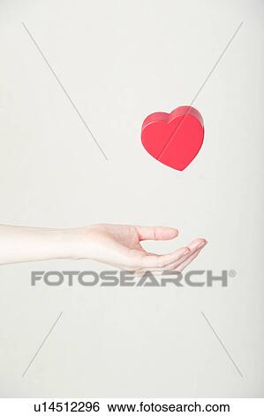 Heart shaped toy in hand View Large Photo Image Stock Photograph - Heart shaped toy in hand. Fotosearch