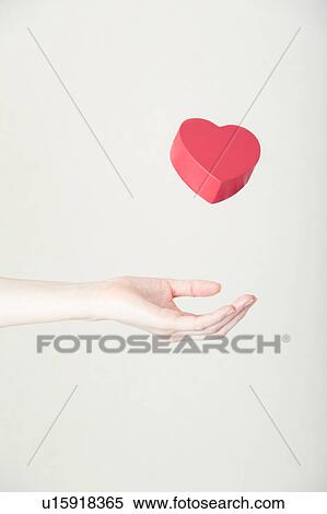 Stock Photography - Heart shaped toy in hand. Fotosearch