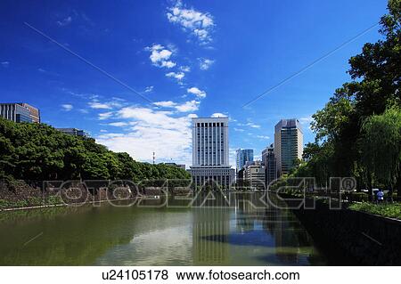 Stock Photo - Hibiya moat and office buildings, Chiyoda Ward, Honshu, Japan. Fotosearch