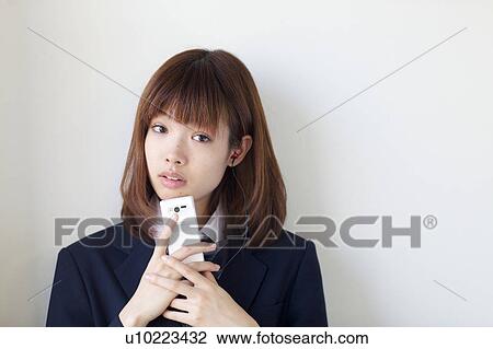 High School Student Listening Music With Mobile Phone and Smiling View Large Photo Image Stock Image - High School Student Listening Music With Mobile Phone and Smiling. Fotosearch