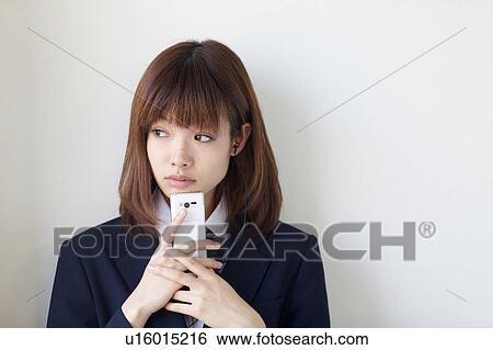 High School Student Listening Music With Mobile Phone and Smiling View Large Photo Image Stock Photograph - High School Student Listening Music With Mobile Phone and Smiling. Fotosearch