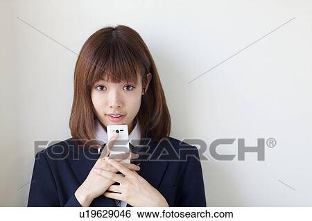 High School Student Listening Music With Mobile Phone and Smiling View Large Photo Image Stock Photograph - High School Student Listening Music With Mobile Phone and Smiling. Fotosearch