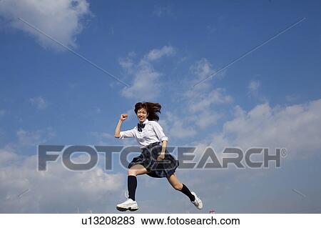 Stock Image - High School Student Running in the air. Fotosearch