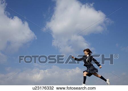 Stock Image - High School Student Running in the air. Fotosearch