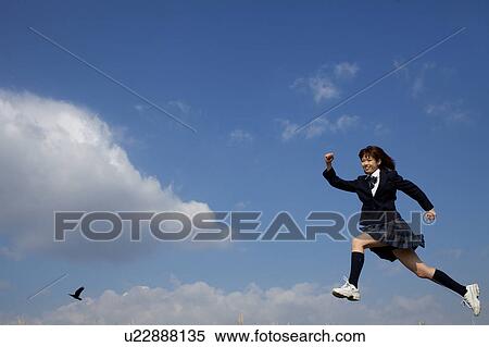Stock Photography - High School Student Running in the air. Fotosearch
