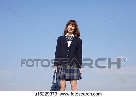 High School Student Standing Against Sky View Large Photo Image Stock Image - High School Student Standing Against Sky. Fotosearch