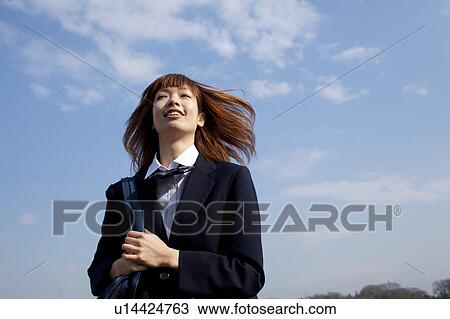 Stock Image - High School Student tossing hair. Fotosearch