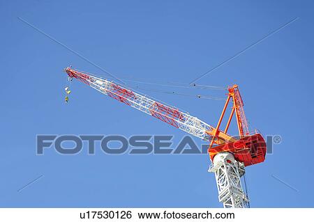 Stock Photograph - Industrial Crane Against Blue Sky. Fotosearch